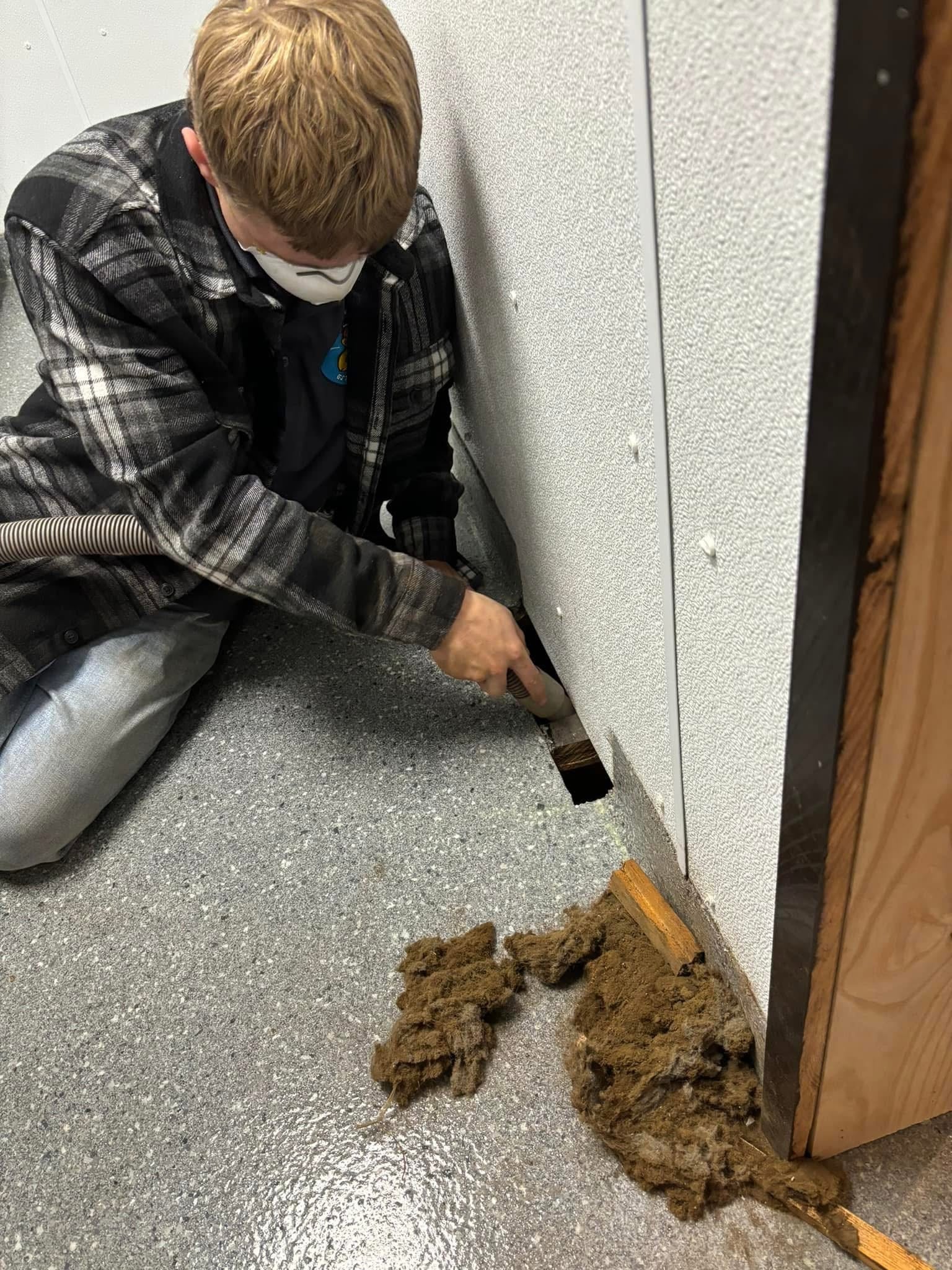 Ike's Duct Cleaning technician removing debris at a commercial property