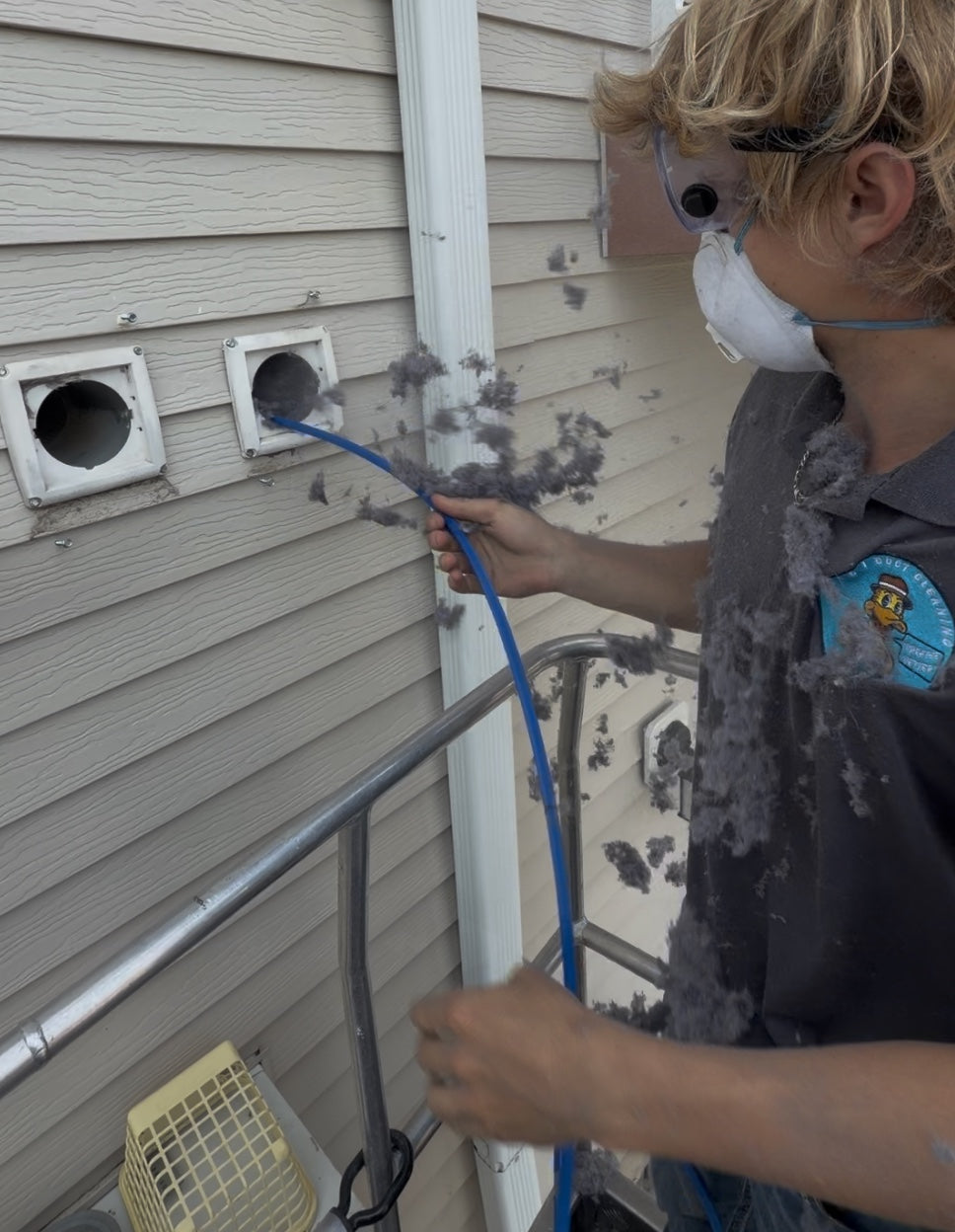 Ike's Duct Cleaning technician cleaning apartment dryer vents
