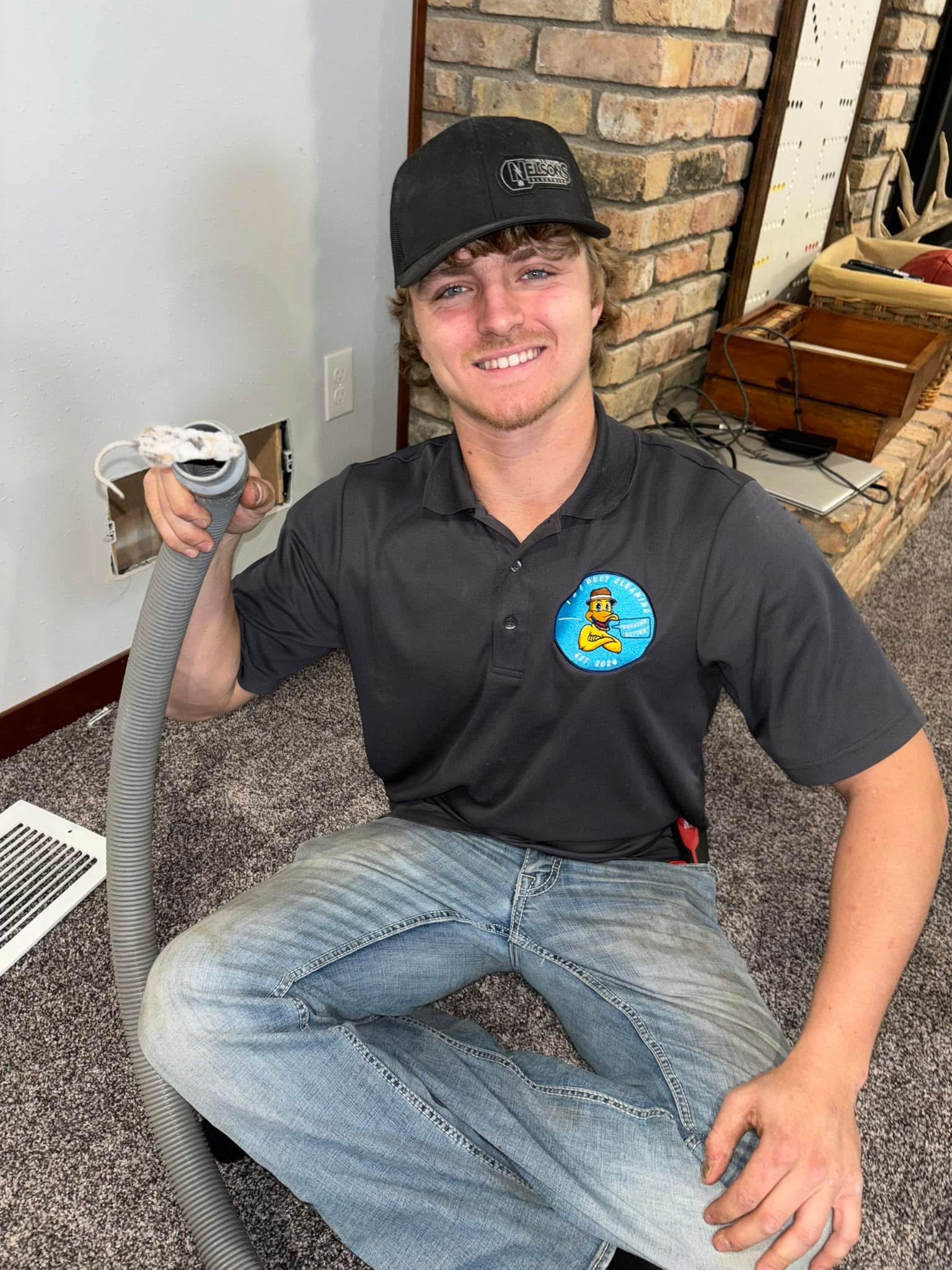 Ike's Duct Cleaning team member on a residential dryer vent job